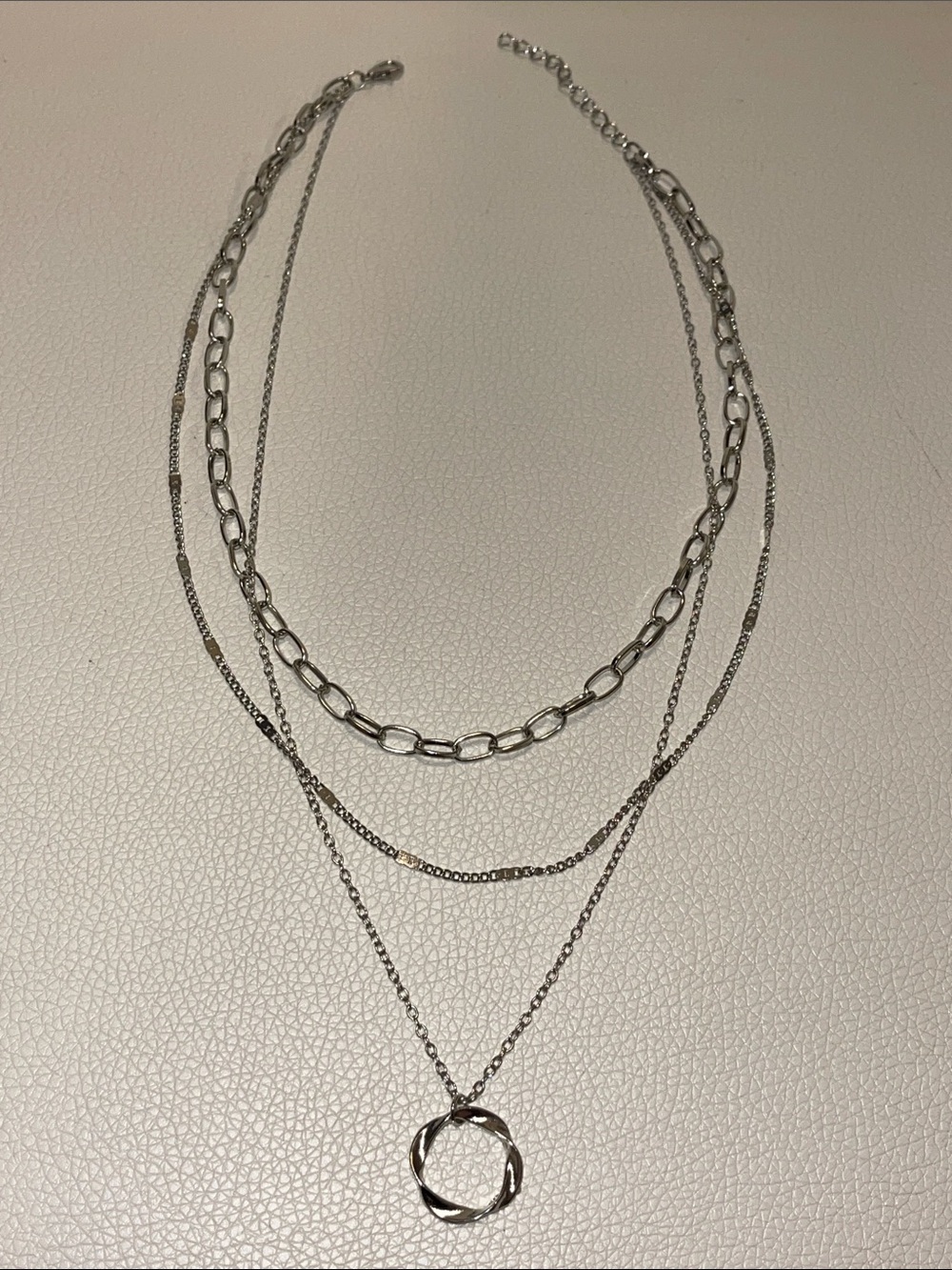 Layered Silver-Tone Multi-Chain Necklace with Twisted Circle Pendant